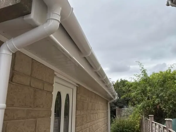 A white gutter gutter on the side of a house.